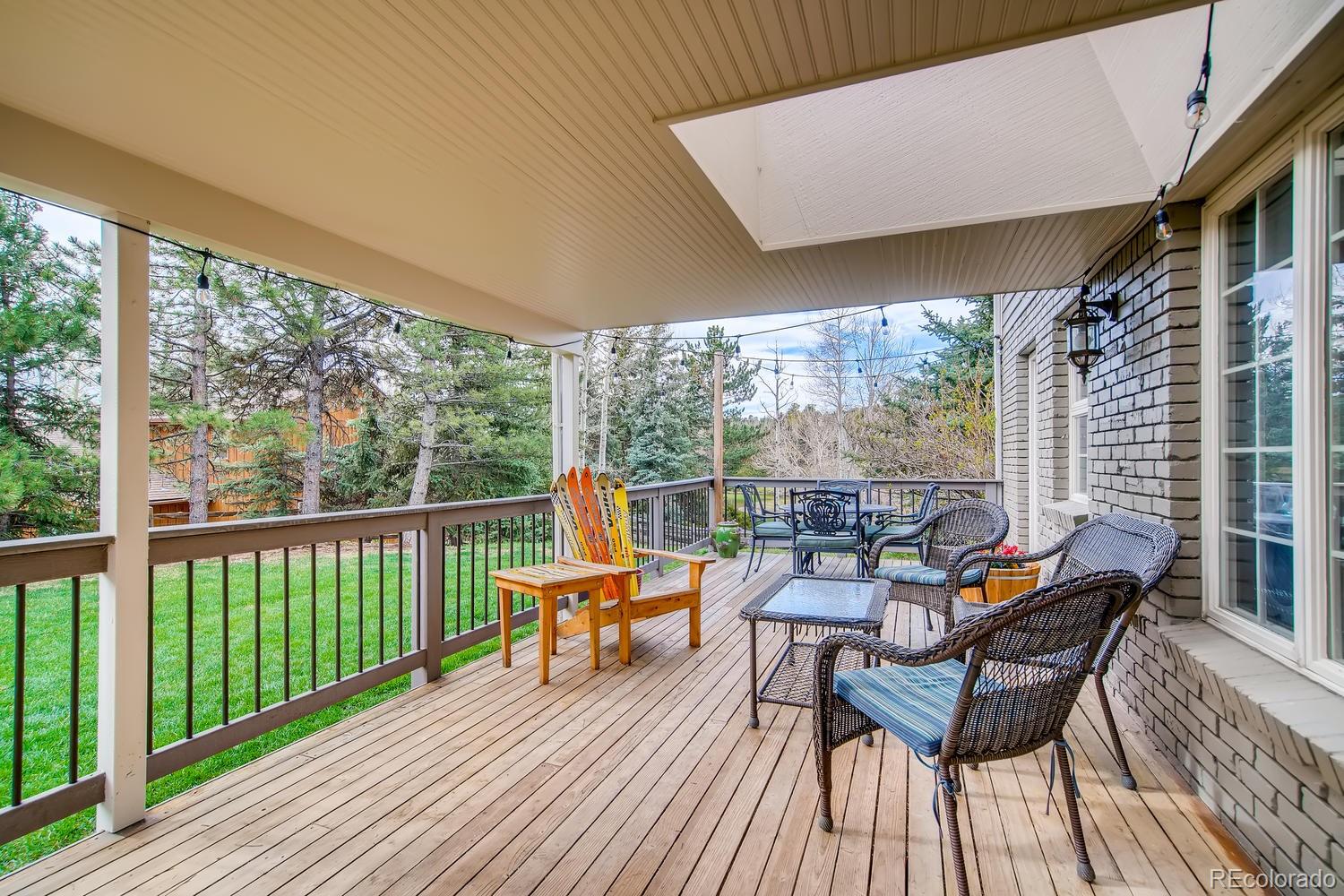 1894 La Quinta Circle Evergreen, CO 80439 - Photo 29 of 36 a balcony with wooden floor table and chairs