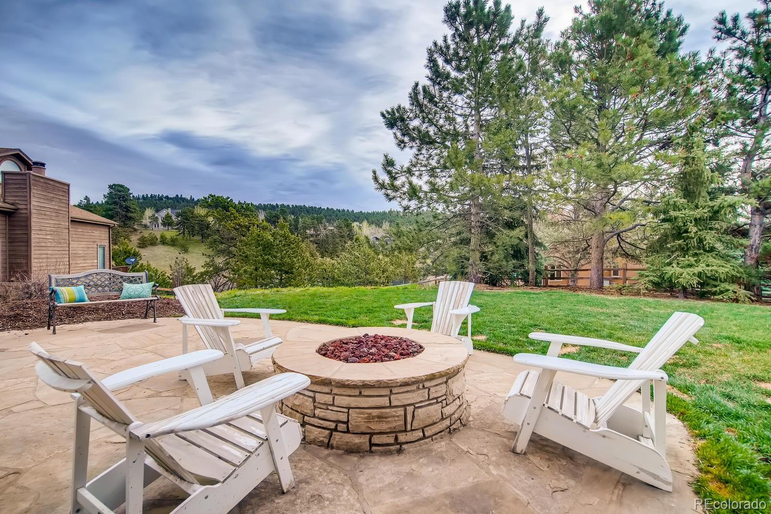 1894 La Quinta Circle Evergreen, CO 80439 - Photo 30 of 36 a view of a chairs and table in backyard of the house