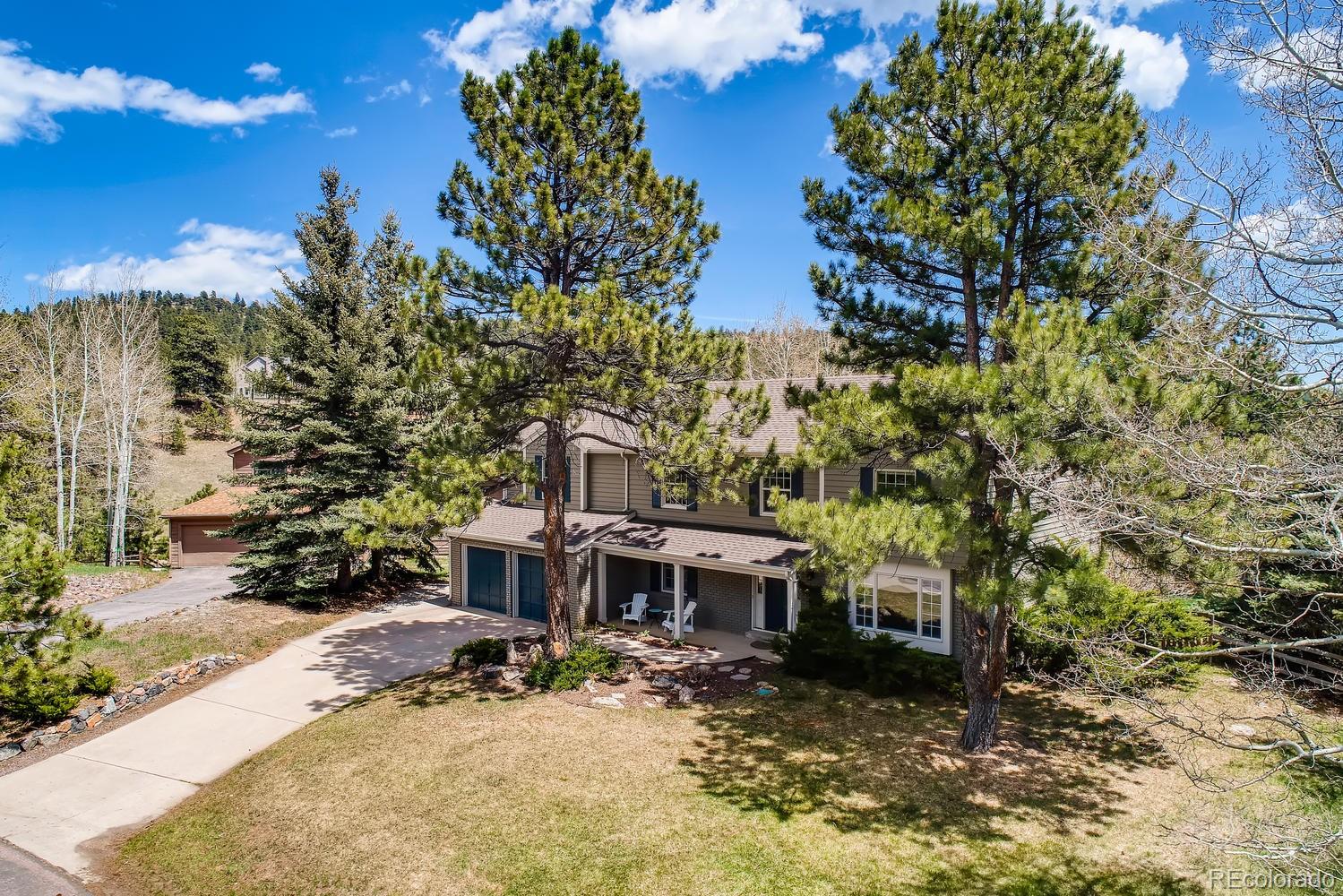 1894 La Quinta Circle Evergreen, CO 80439 - Photo 3 of 36 a view of a house with backyard and sitting area