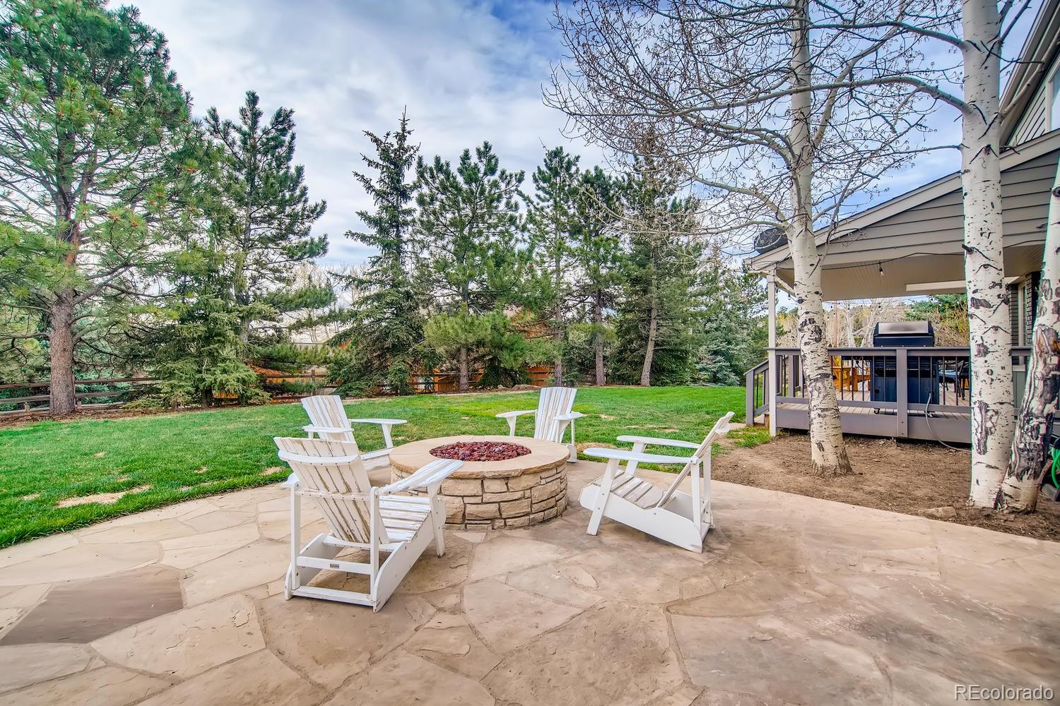 1894 La Quinta Circle Evergreen, CO 80439 - Photo 31 of 36 a view of a chair and tables in the back yard of the house
