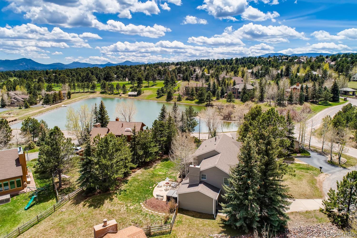 1894 La Quinta Circle Evergreen, CO 80439 - Photo 4 of 36 a view of a lake with lawn chairs