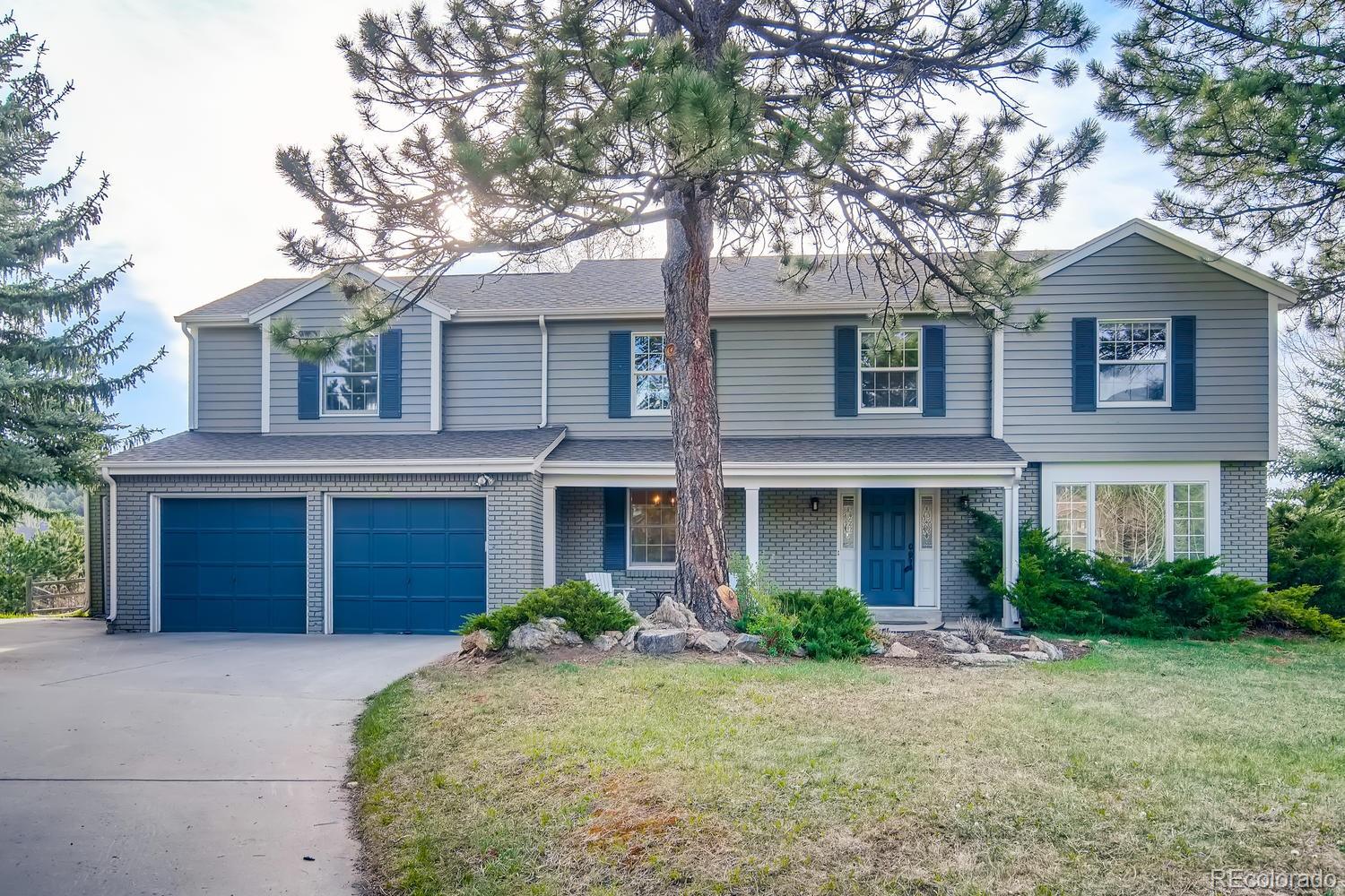 1894 La Quinta Circle Evergreen, CO 80439 - Photo 6 of 36 a front view of house with yard and trees around
