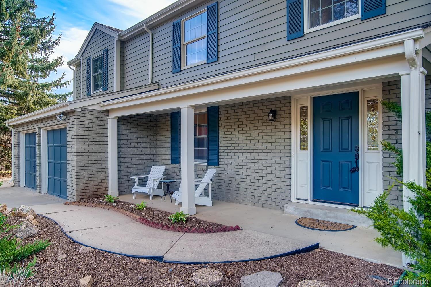 1894 La Quinta Circle Evergreen, CO 80439 - Photo 7 of 36 a front view of a house with a porch