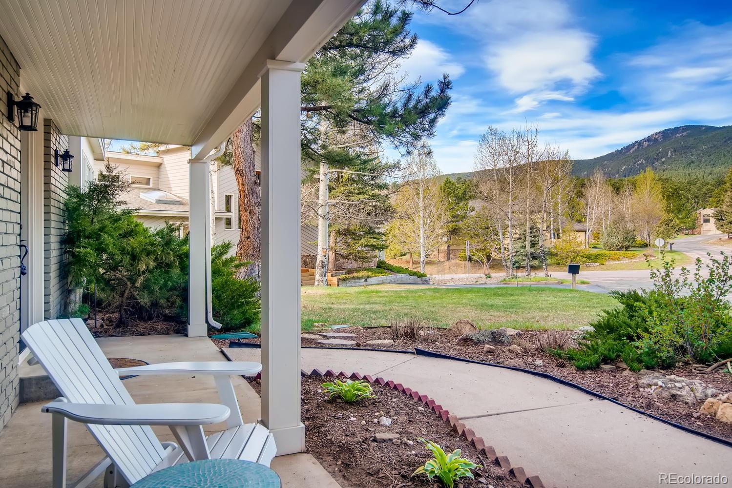 1894 La Quinta Circle Evergreen, CO 80439 - Photo 8 of 36 a view of a patio with table and chairs and potted plants