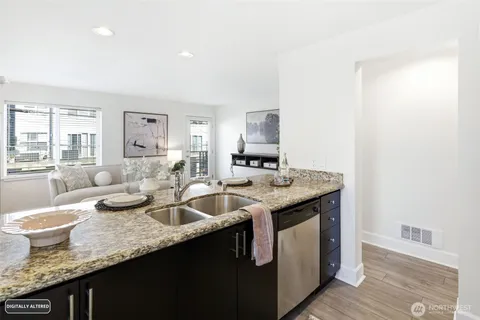 a kitchen with sink refrigerator dining table and chairs