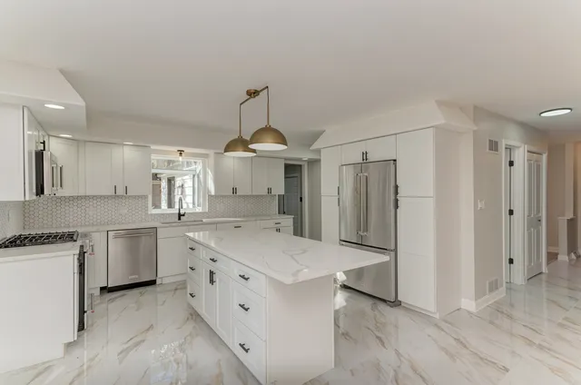 a kitchen with a sink stainless steel appliances and cabinets