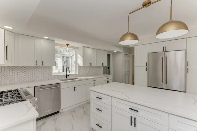 a spacious bathroom with a double vanity sink a mirror and a shower