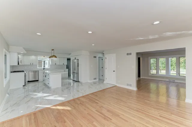 a view of a kitchen with wooden floor