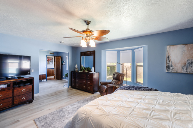 1470 Redwood Tree Street St. George, UT 84790 - Photo 12 of 53 Light wood-finish flooring complements the room's blue walls