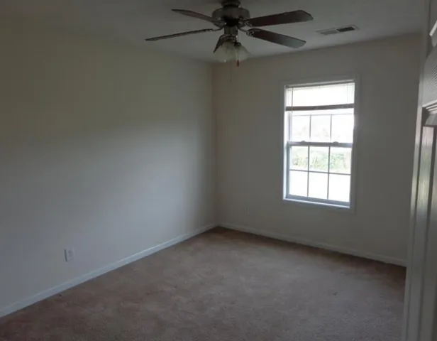 a view of a chandelier fan in big room