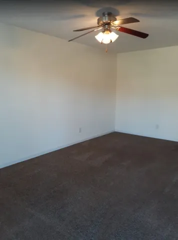 a bathroom with a granite countertop toilet and a sink