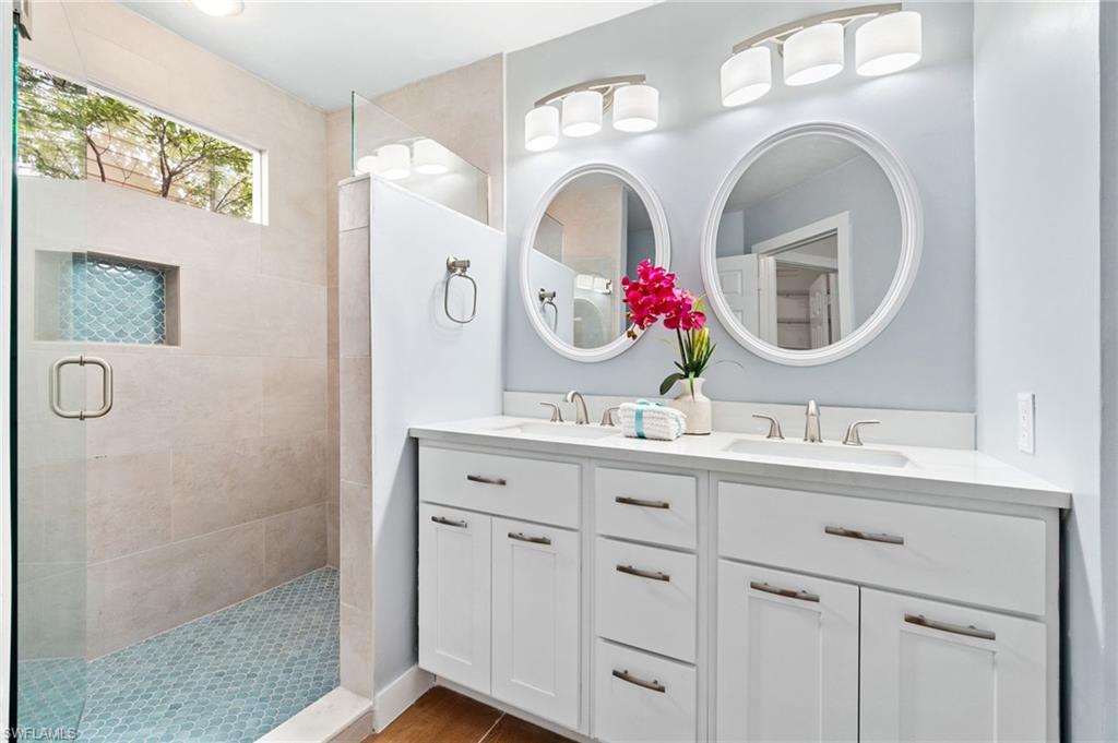 2662 Aft Avenue Naples, FL 34109 - Photo 7 of 26 Full bathroom featuring double vanity and a stall shower