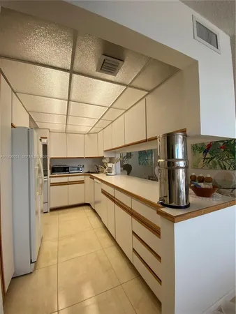 a kitchen with a sink appliances and cabinets