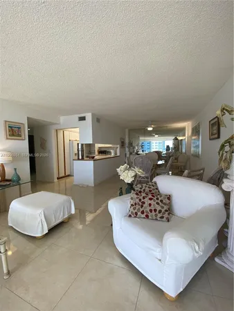 a living room with furniture and a large mirror with rug