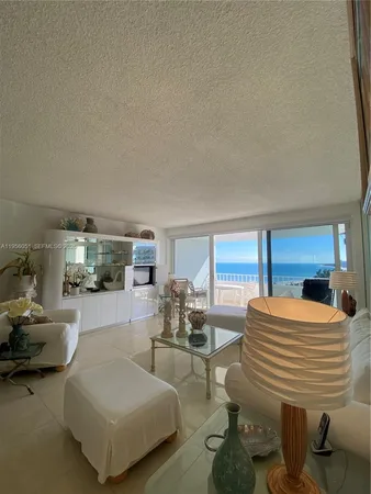 a living room with furniture and large windows