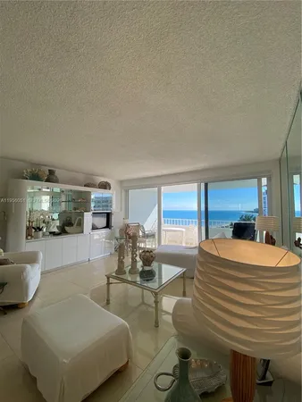 a bedroom with furniture and a large window