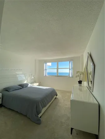 a bedroom with a bed and a dresser next to it