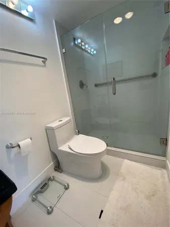 a white toilet sitting next to a bathroom sink