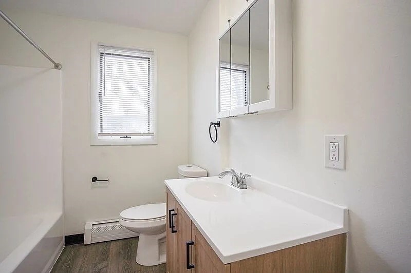 878-880 St James Avenue Springfield, MA 01104 - Photo 14 of 17 a bathroom with a sink a toilet and a window