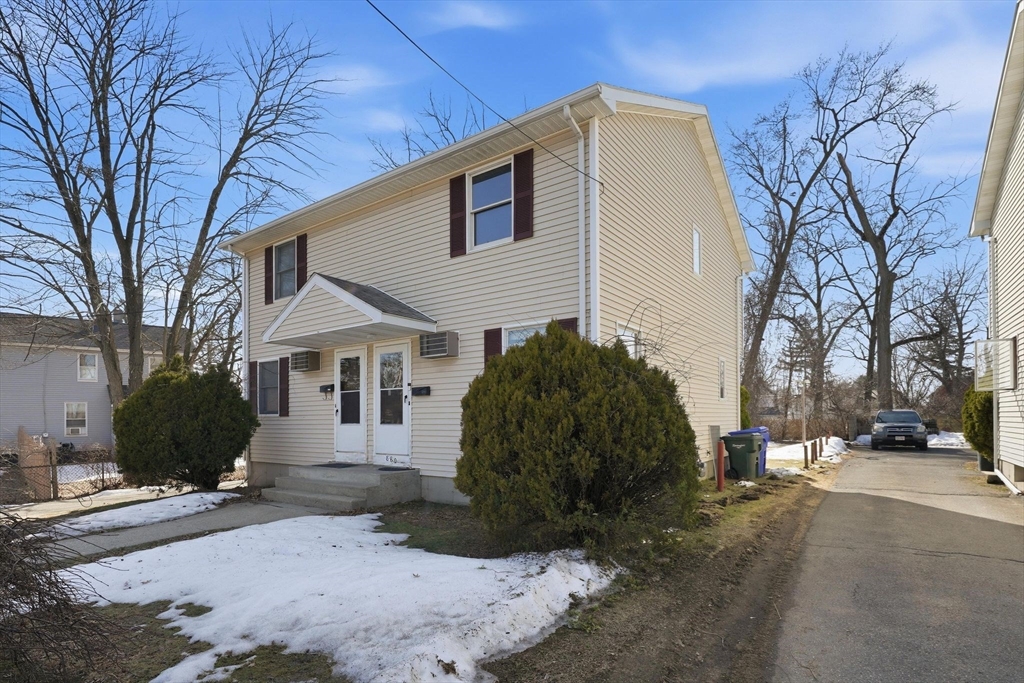878-880 St James Avenue Springfield, MA 01104 - Photo 2 of 17 a view of a white house with a yard covered with snow