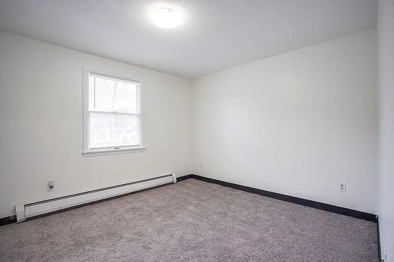878-880 St James Avenue Springfield, MA 01104 - Photo 7 of 17 an empty room with a window
