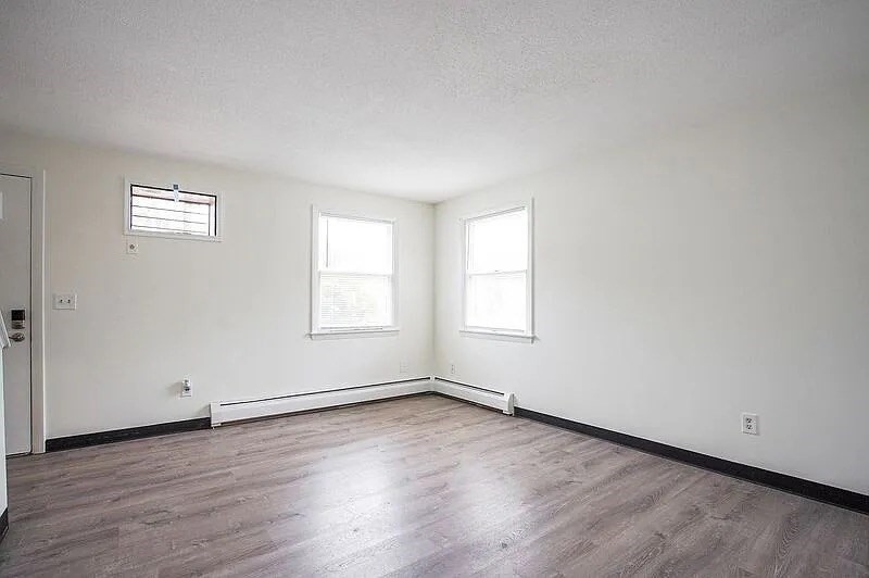 878-880 St James Avenue Springfield, MA 01104 - Photo 8 of 17 an empty room with wooden floor and windows