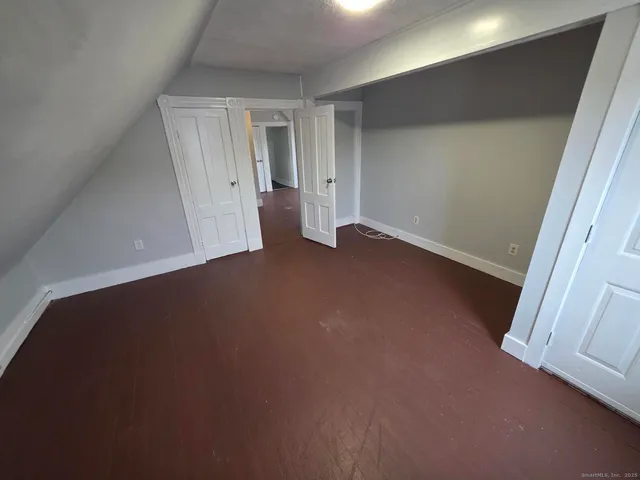 a view of entryway with window and wooden floor