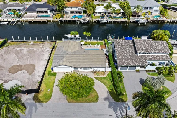 an aerial view of a house with outdoor seating