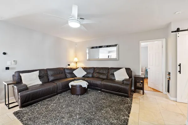 a living room with furniture and a chandelier
