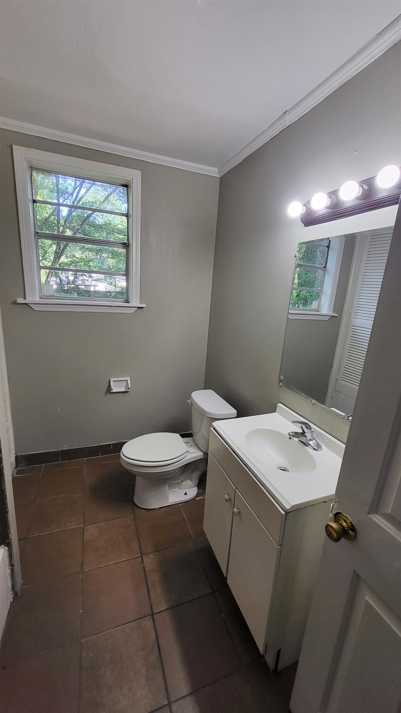 3758 Elliston Road Memphis, TN 38111 - Photo 4 of 6 Bathroom featuring tile patterned floors, toilet, vanity, and ornamental molding
