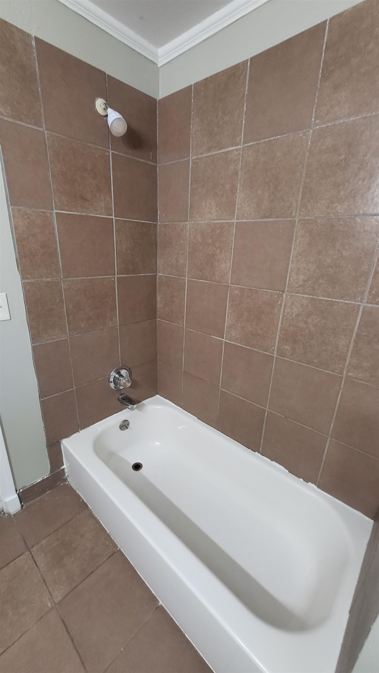 3758 Elliston Road Memphis, TN 38111 - Photo 5 of 6 Bathroom featuring tile patterned floors, crown molding, and shower combination