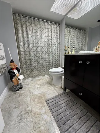 a bathroom with a toilet a sink and a shower
