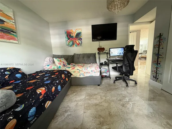 a bedroom with a bed and a flat screen tv