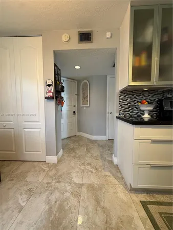 a view of a hallway to rooms and wooden floor