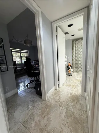 a kitchen with granite countertop a stove and white cabinets