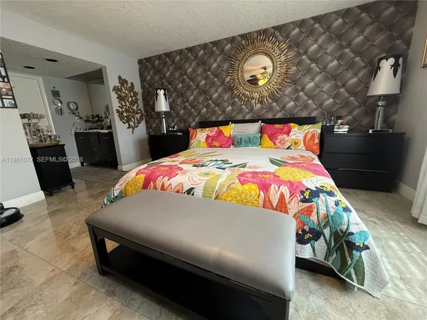 a bedroom with a bed and dresser