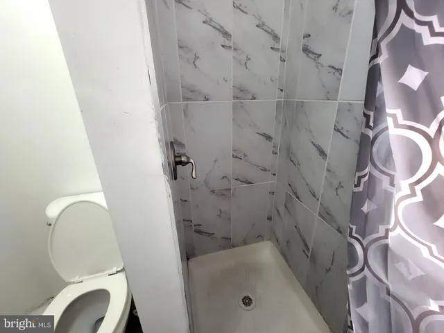 a bathroom with a tub and toilet