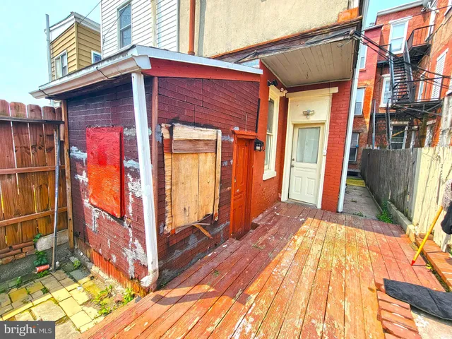 a view of a house with wooden fence