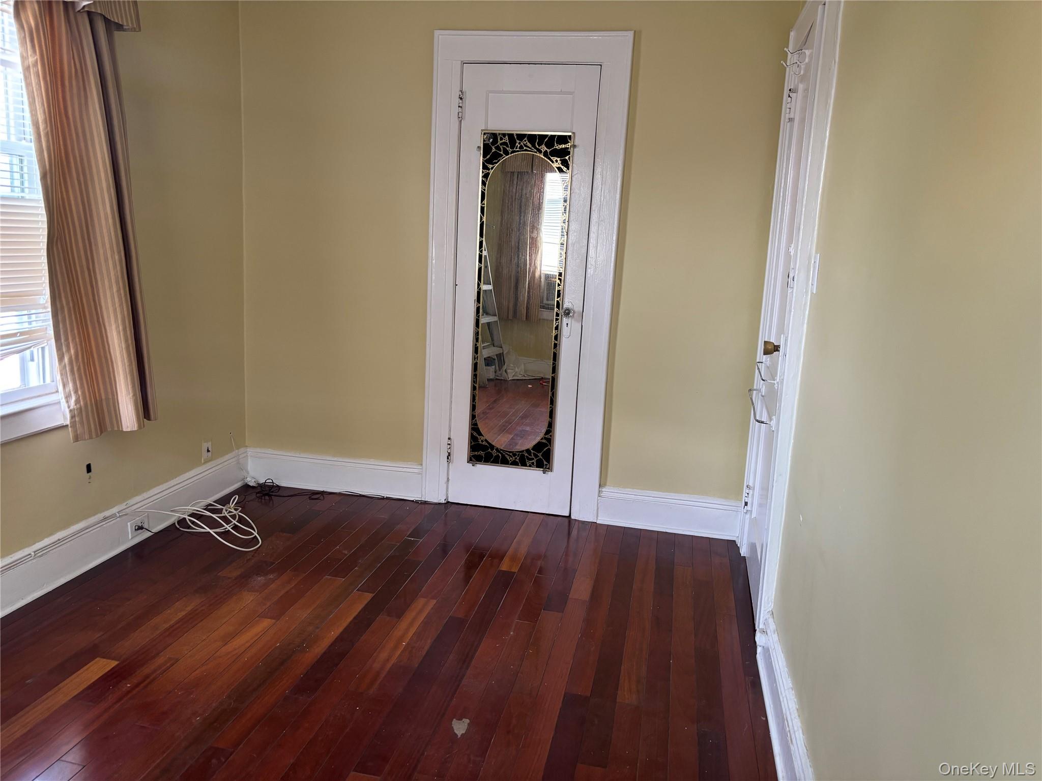 104-18 216th Street Queens, NY 11429 - Photo 38 of 49 Unfurnished room featuring dark wood-style flooring and plenty of natural light