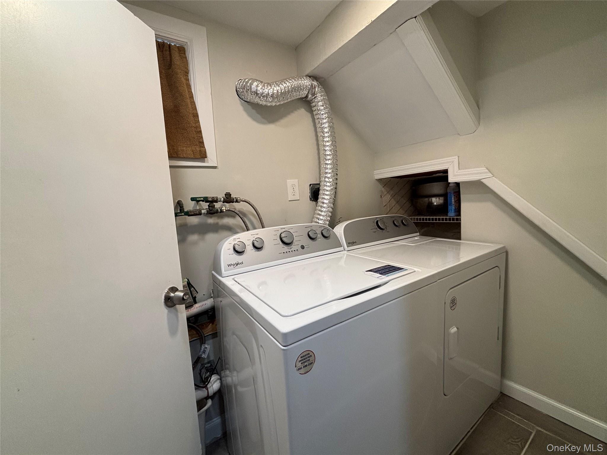 104-18 216th Street Queens, NY 11429 - Photo 41 of 49 Laundry room featuring independent washer and dryer and baseboards