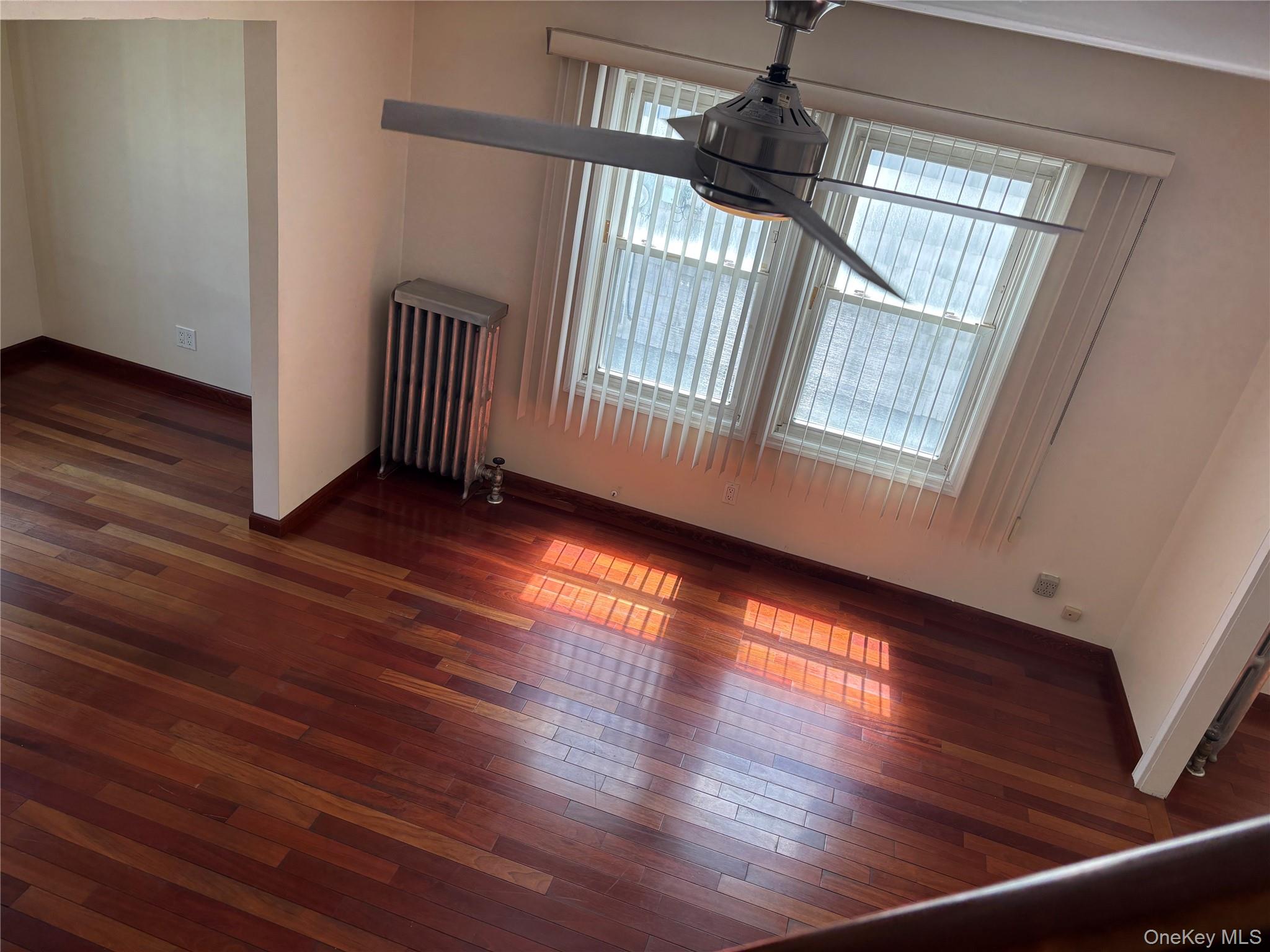 104-18 216th Street Queens, NY 11429 - Photo 8 of 49 Unfurnished dining area featuring dark wood-type flooring and radiator heating unit