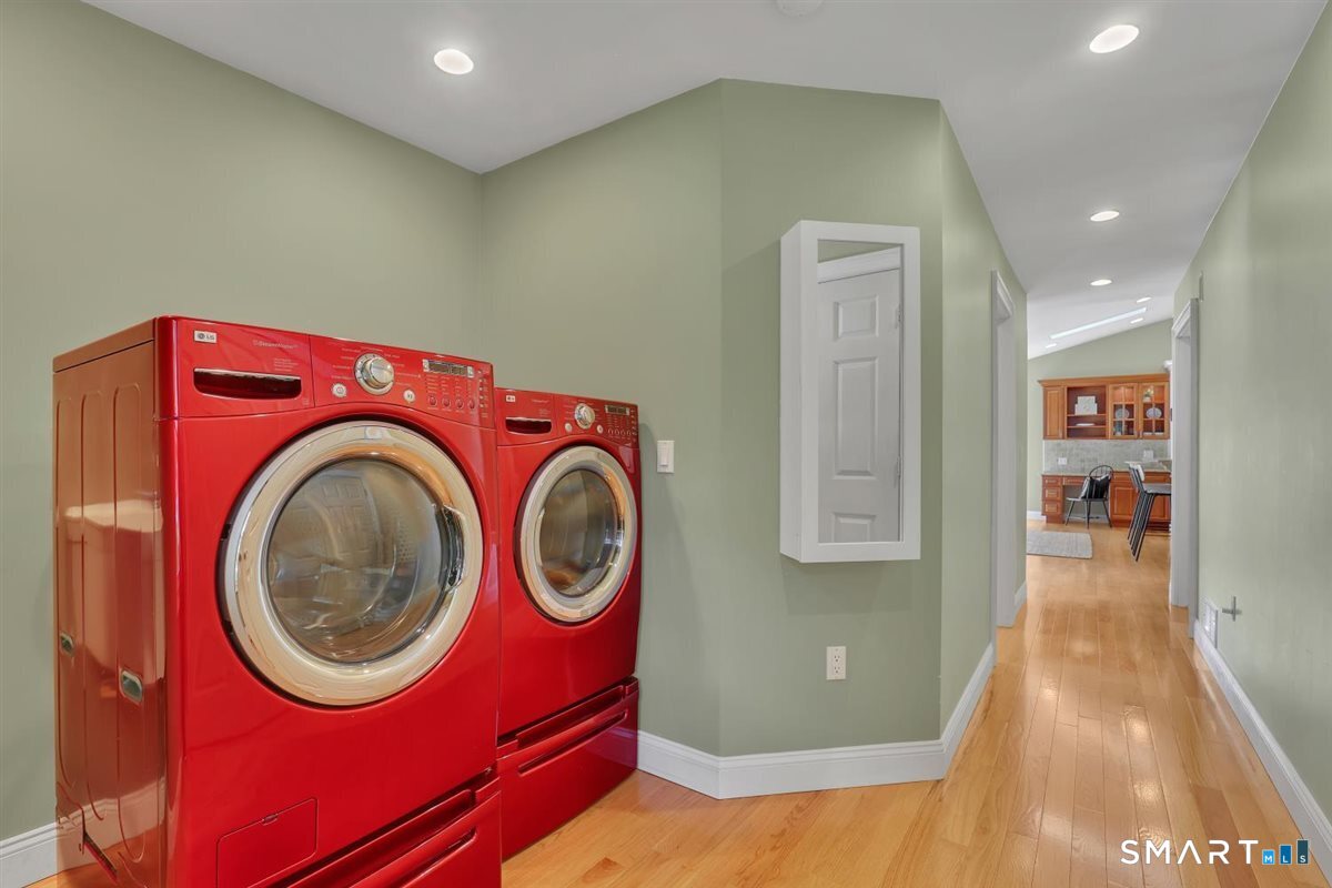 361 Miles Road Orange, CT 06477 - Photo 11 of 40 Convenient laundry room at the end of the hall, featuring hardwood flooring, utility sink, and a large walk-in closet with built-ins for exceptional storage. Includes LG washer and dryer.