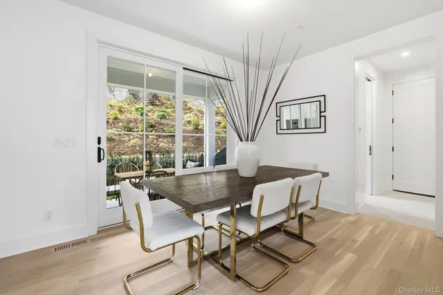 a kitchen with a table chairs stove and wooden floor