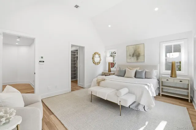 a spacious bedroom with a bed and glass window