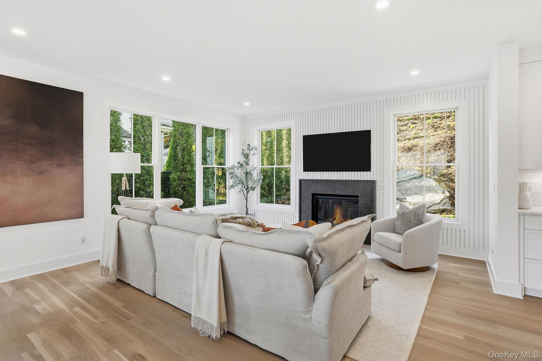 80 Grapal Street Rye, NY 10580 - Photo 4 of 38 a living room with furniture a fireplace and a flat screen tv