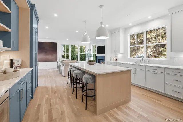 a living room with furniture and a view of kitchen