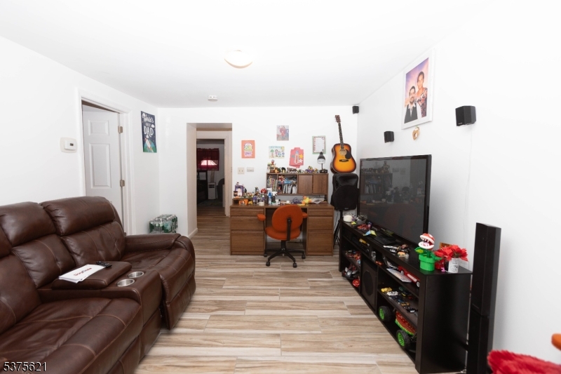 622 North 9th Street Newark, NJ 07107 - Photo 13 of 24 a living room with furniture and a flat screen tv