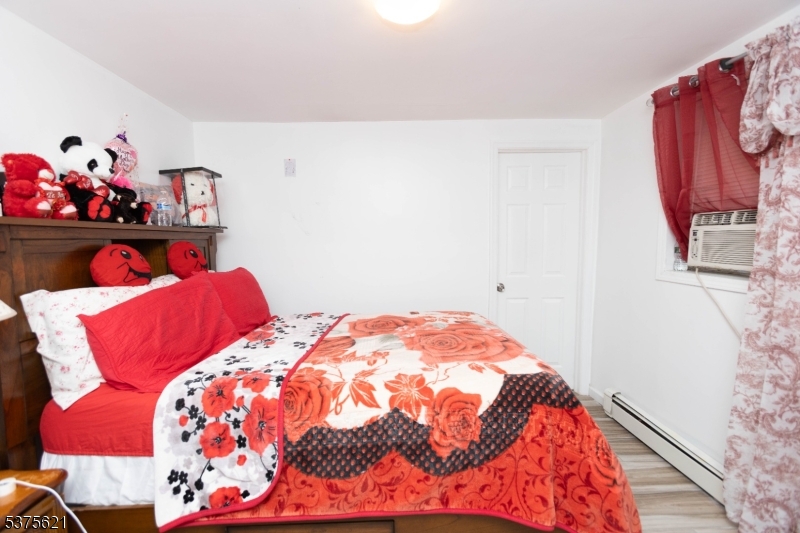 622 North 9th Street Newark, NJ 07107 - Photo 14 of 24 a bedroom with a bed and a window