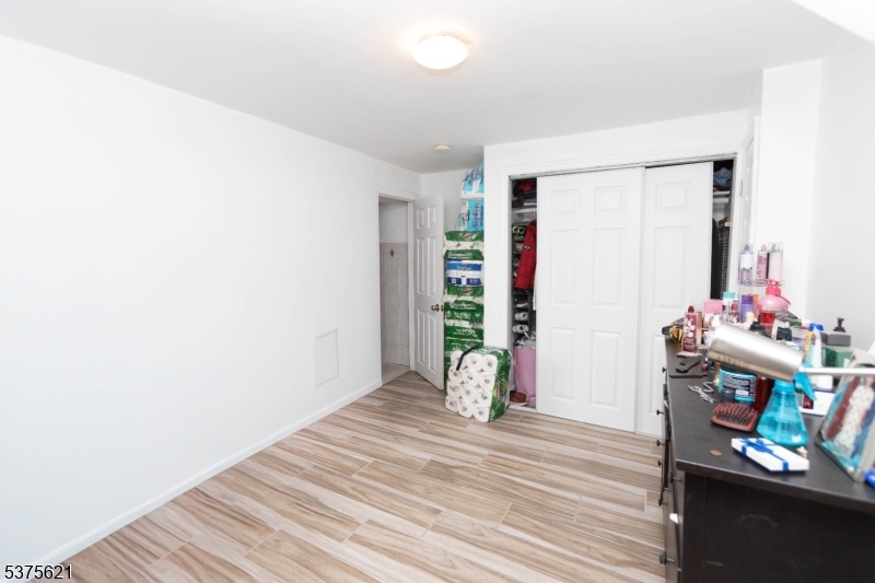 622 North 9th Street Newark, NJ 07107 - Photo 15 of 24 a view of an empty room with wooden floor and a window