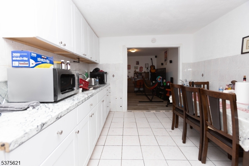 622 North 9th Street Newark, NJ 07107 - Photo 17 of 24 a kitchen with granite countertop a cabinets and a stove top oven
